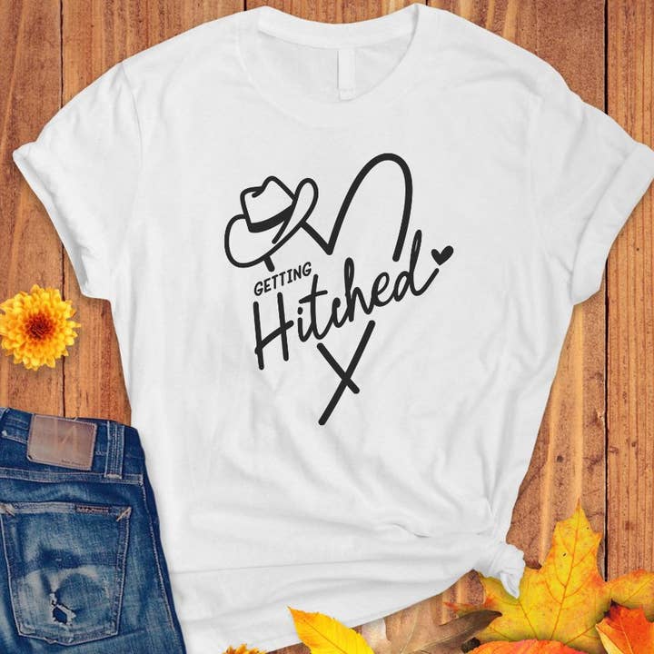 Getting Hitched Cowboy Western Engagement Wedding T Shirt for wholesale by Sister Ray