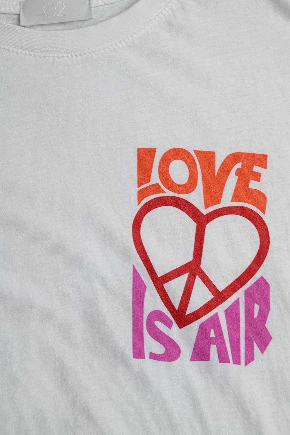 White T-Shirt with Love is Air and Heart with Peace logo for wholesale on Faire8