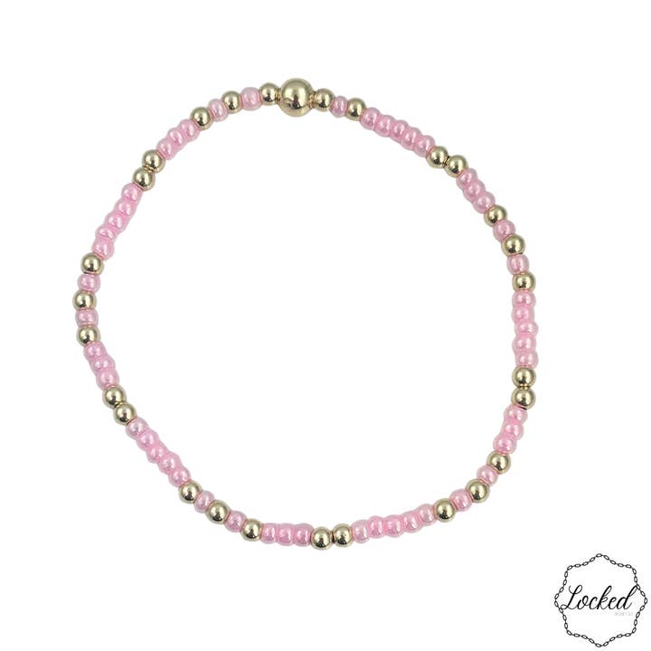 Bracelet en perles dorées rempli de lueur rose pour la vente par Locked by Lula 'n' Lee