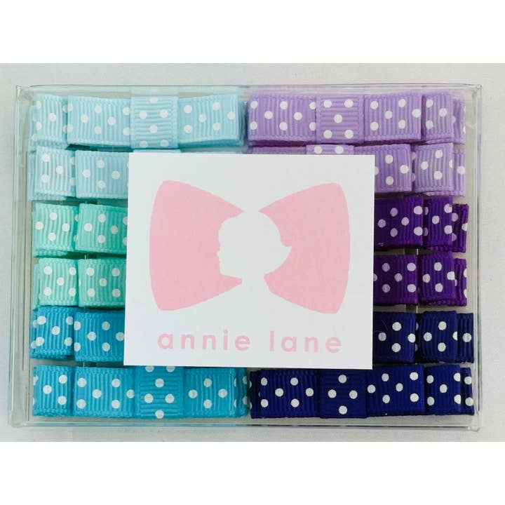 Boîte de 12 nœuds pour cheveux - paires à pois bleu/violet pour la vente par Annie Lane