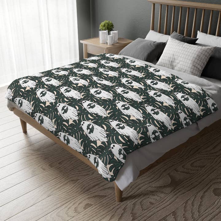 Ghost Blanket Printed on Both Sides. Soft Large Halloween blanket 80x60 Inches. Ghost holding a monstera leaf for wholesale by Ficus and Plants LLC