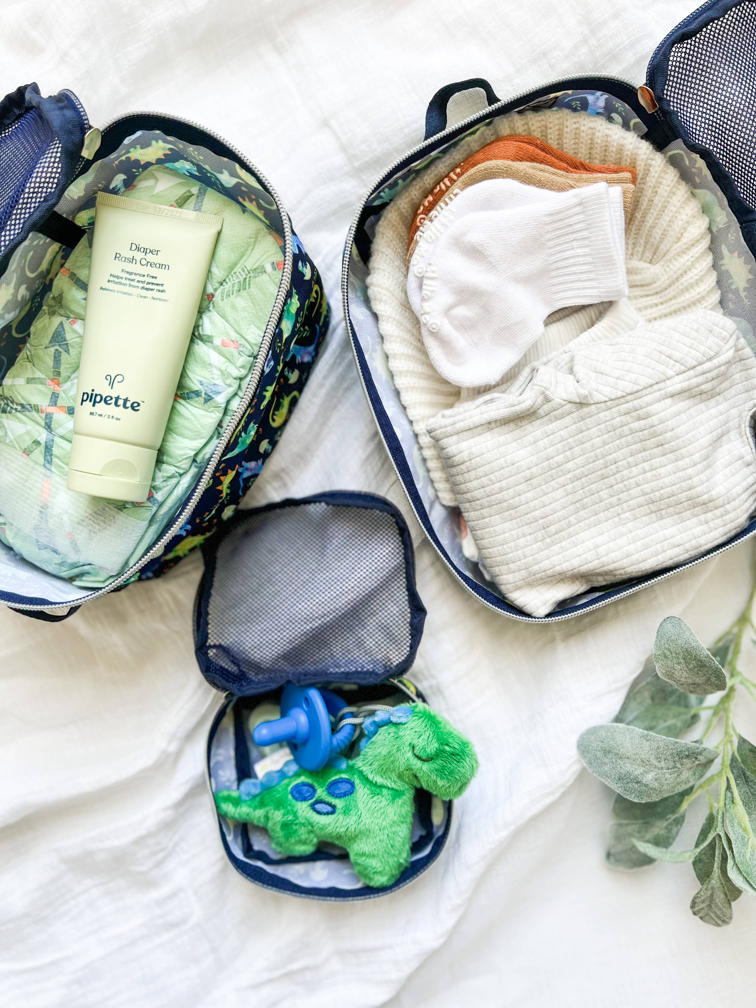 Itzy Ritzy - Wholesale Diaper Backpack/Bag - Kids & Baby - NEW Pack Like a Boss™ Raining Dinos Diaper Bag Packing Cubes on Faire.com