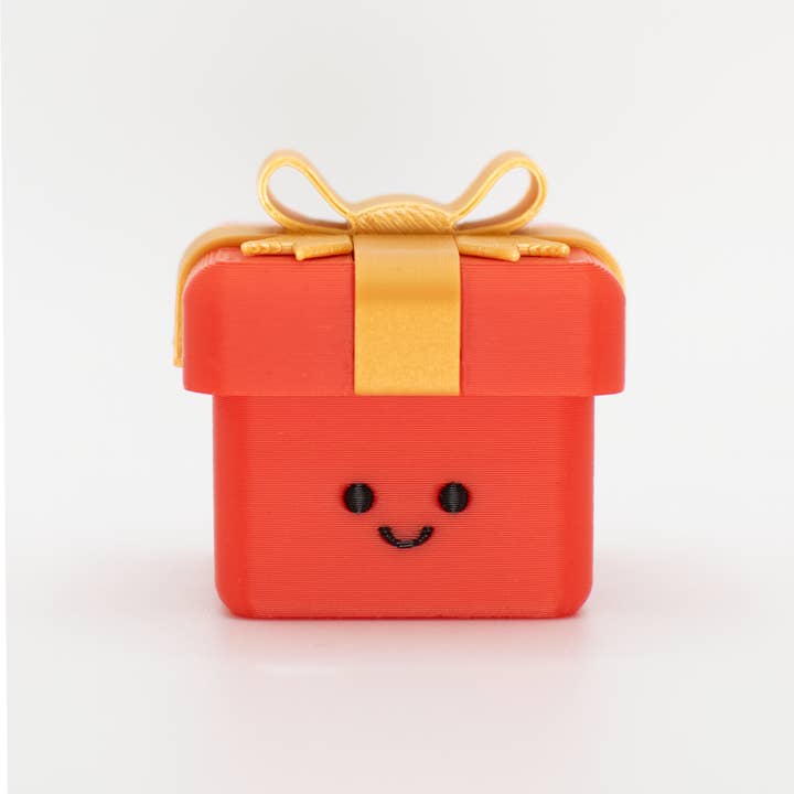 Happy Clicky Present Desk Buddy for wholesale by The Tiny Joy Factory