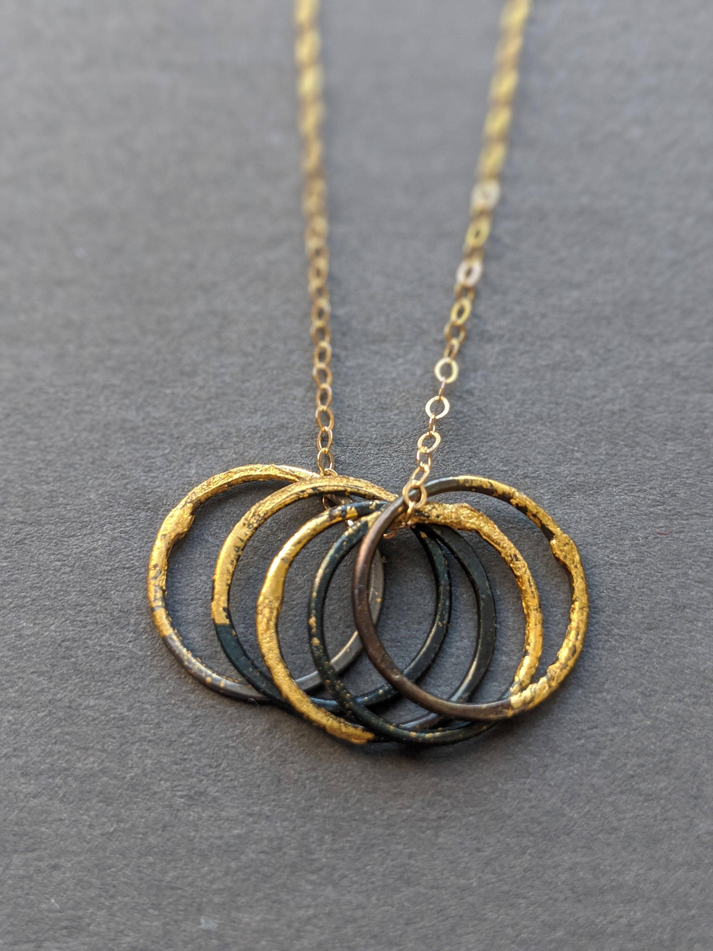 Metamorphosis Metals - Wholesale Pendant/Charm Necklace - Steel & Gold 5 Loose Circles Necklace1