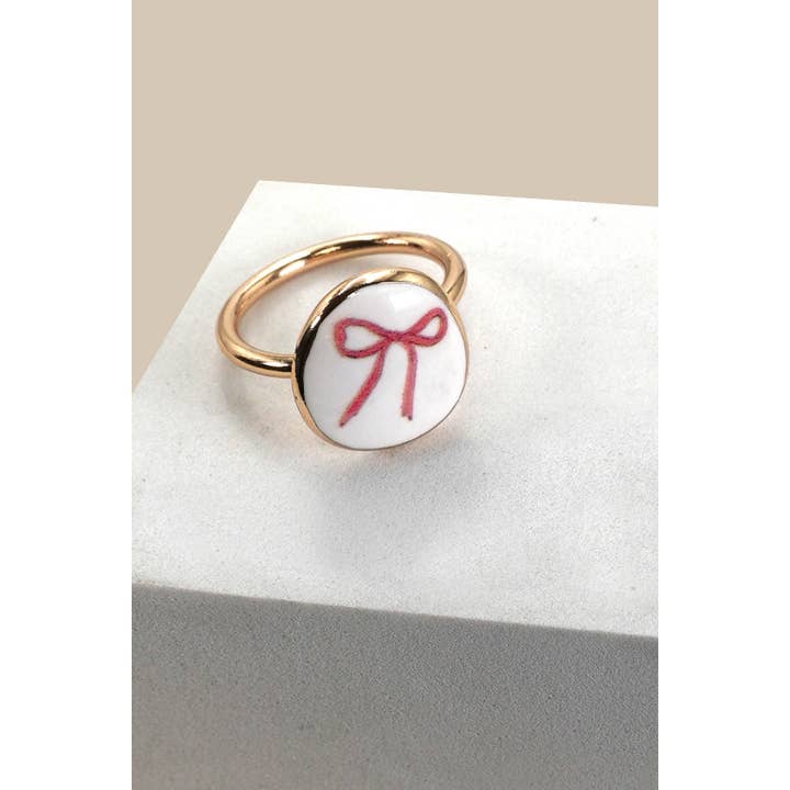 PORCELAIN GOLD EDGED BOW CHARM RING | 80R031 for wholesale on Faire