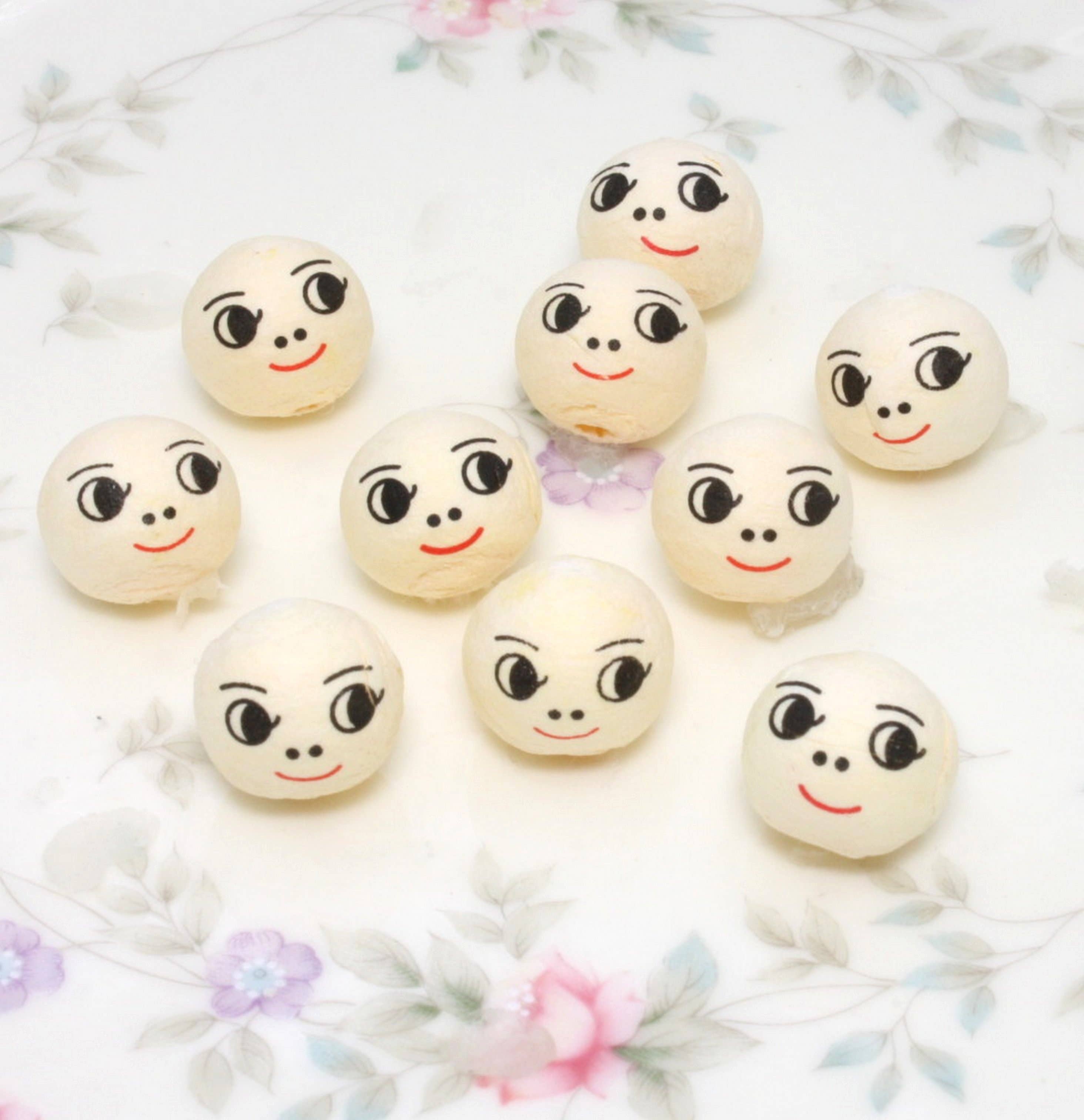 Doll Heads - 1/2" Spun Cotton with Faces - Set of 10 for wholesale on Faire0