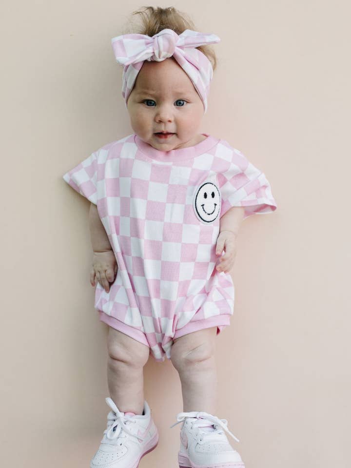 Short Sleeve Bubble Romper | Checkered Smiley Pink for wholesale by Lucky Panda Kids