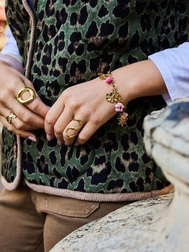 Gold Stainless Steel Bracelet with Flower, Heart, and Sun Charms for wholesale by BELLISSIMA BIJOUX