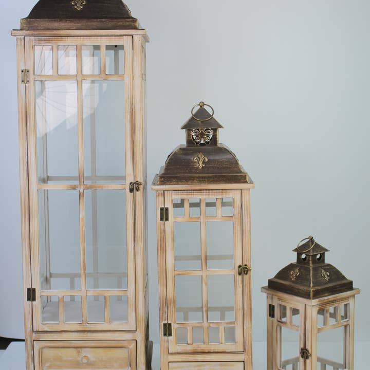 Wholesale Home Decor – Großhandel Laterne – Set aus 3 Laternen aus Holz und Metall mit Schublade – 46 cm, 81 cm und 122 cm1