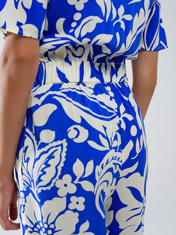 Blå Blå jumpsuit med kort ärm, knytbar nyckelhåls-urringning och blommönster för wholesale på Faire4