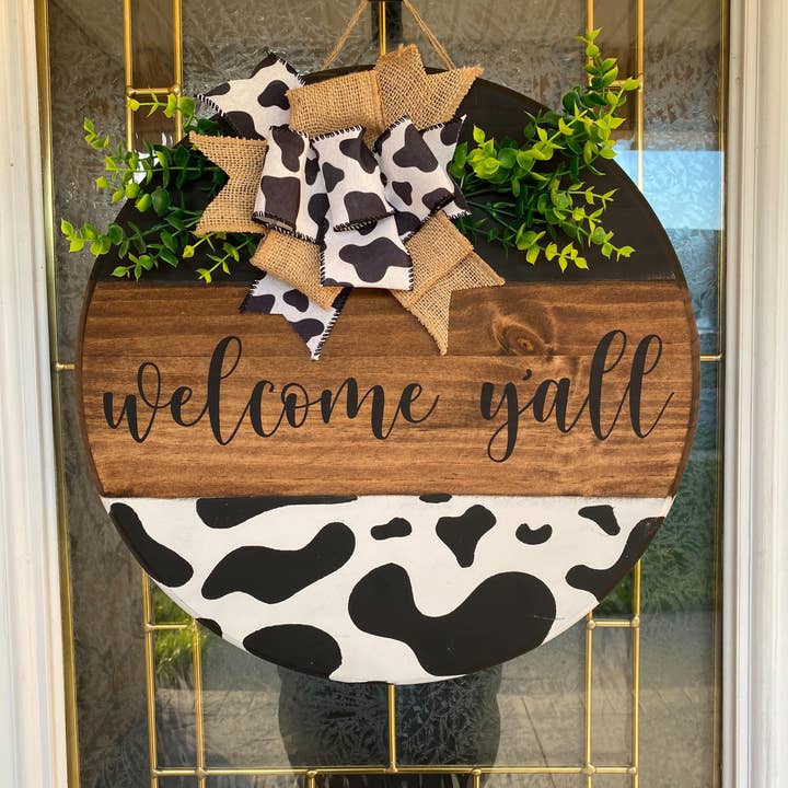 Welcome Y'all Cow Print Door Hanger for wholesale by Timbered Roots Co