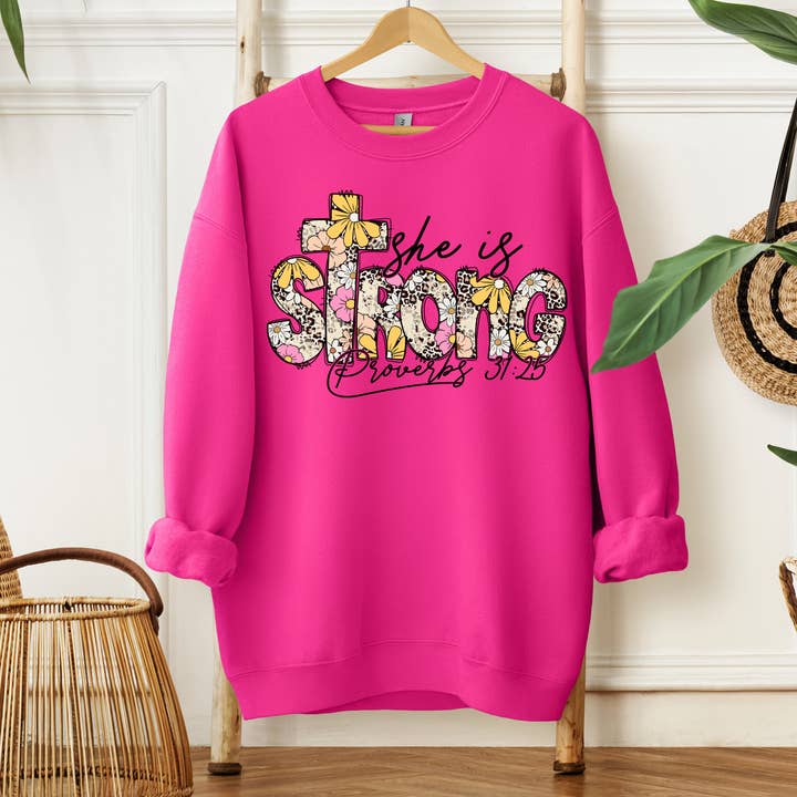 She is Strong Floral Christian Sweatshirt for wholesale by Southern Girl Supply Co