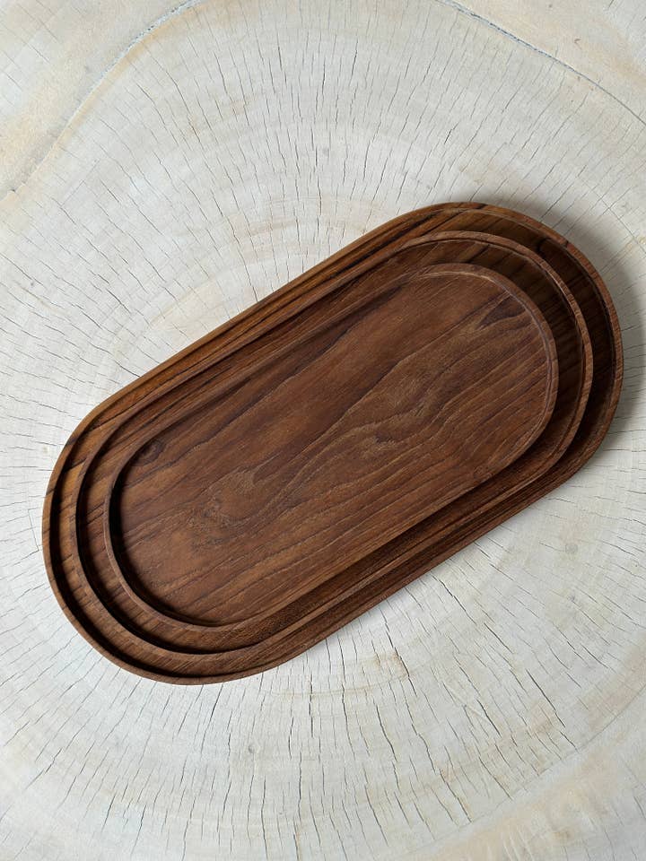 Trio of small trays or oval bowls in monoxyl teak for wholesale by Office Objets