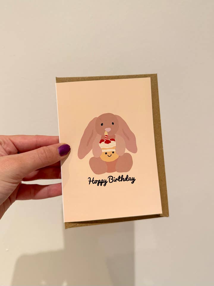 "Hoppy Birthday" birthday card. Bunny and cake. A6 for wholesale by Gallerybylara