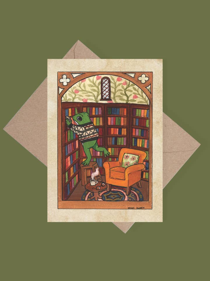 Frog in a library cosy bookish greetings card for wholesale by Holly Sweet illustration