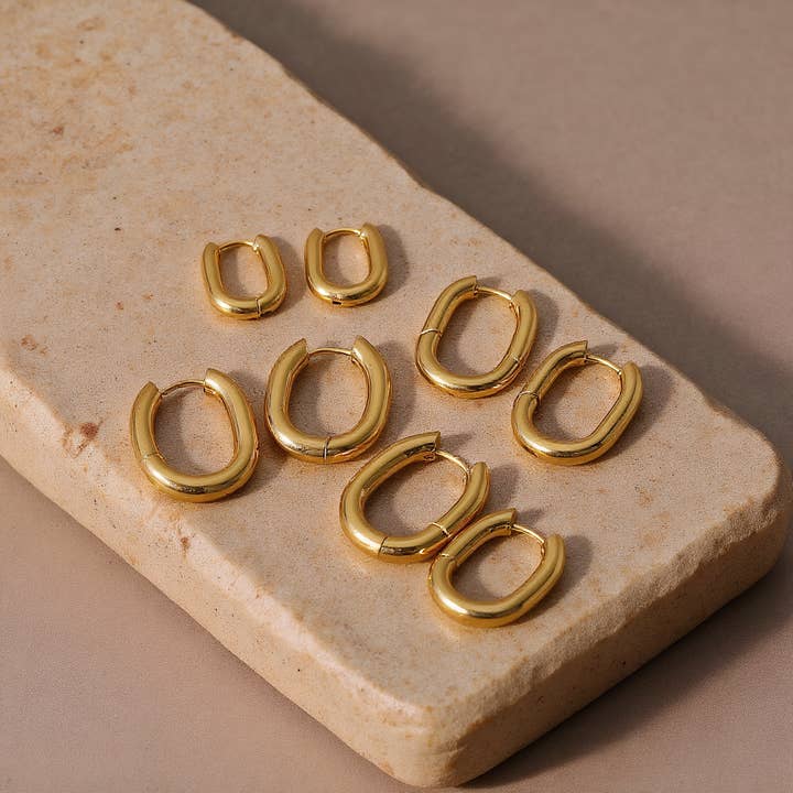 8K Gold Stainless Steel Oval Huggie Earrings for wholesale by Revelari