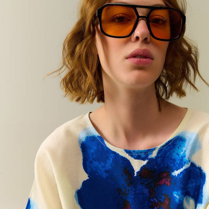 Sunglasses with black frames and orange lenses for wholesale on Faire2