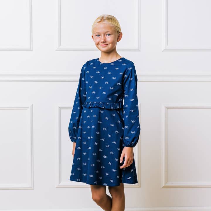 Navy Bicycle Print Ruffle Waist Dress - Made with Organic Cotton for wholesale on Faire
