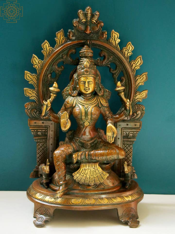 11" Goddess Lakshmi with Kirtimukha Prabhavali In Brass for wholesale by Exotic India Art