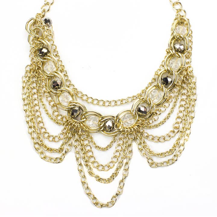Elegant Gold Tone Crystal Bib Statement Necklace with Draped Chains and Matching Earrings for wholesale by LookLove Jewelry