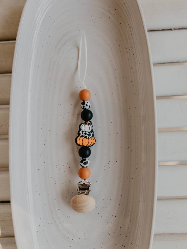 Cowprint Pumpkin Pacifier Clip for wholesale by Bar Tabs Wholesale