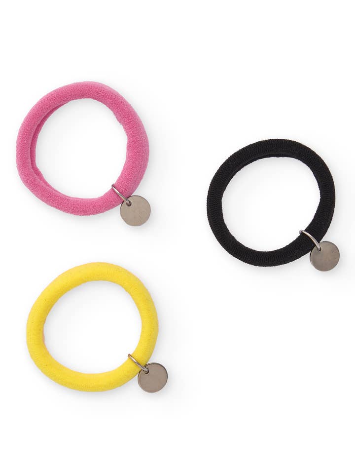 Scrunchies for girls in assorted colors with a metallic charm for wholesale by tuc tuc