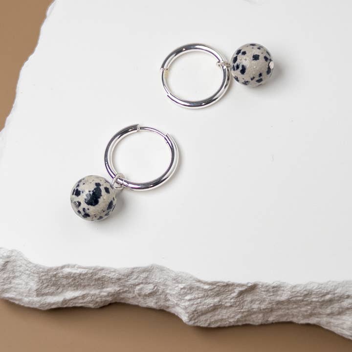 Silver Huggie Earrings with Removable Dalmation Jasper Charm for wholesale by Mingled