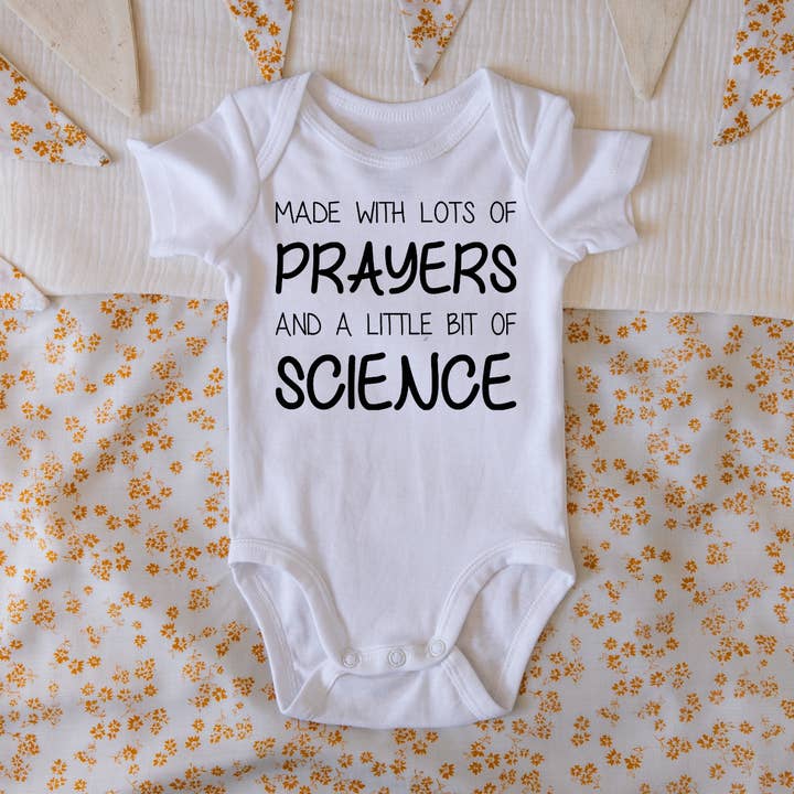 Prayers & Science IVF Pregnancy Announcement Onesie for wholesale by Claire and Bella