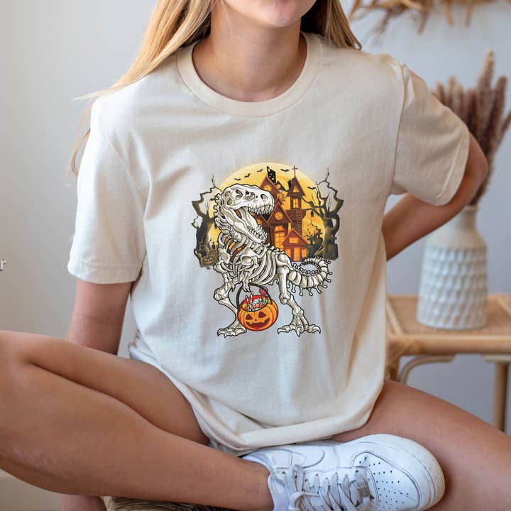 Skeleton Dinosaur Trick or Treat Shirt, T-rex Halloween Tee for wholesale by NVC Ecommerce LLC
