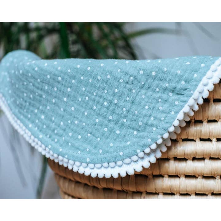 Sea green polka dot pompon blanket for wholesale by Natural Cuddles