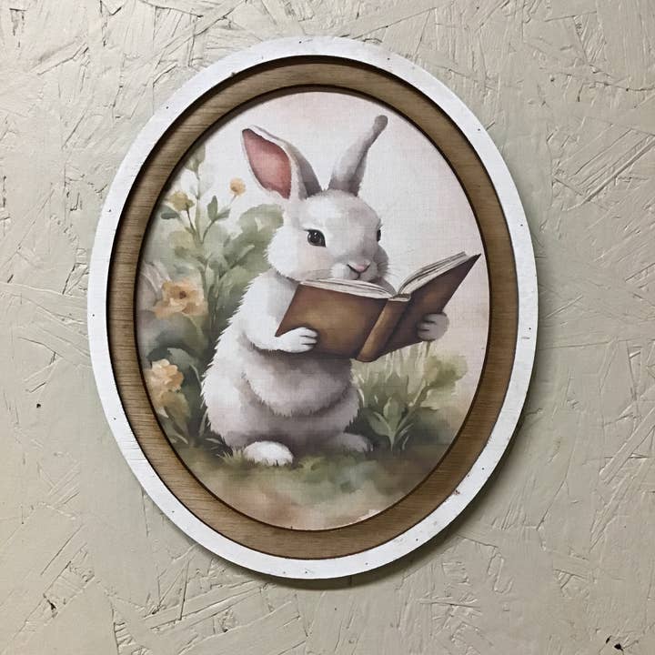 Oval Frame Bunny Reading Book Print for wholesale by LAND OF COTTON
