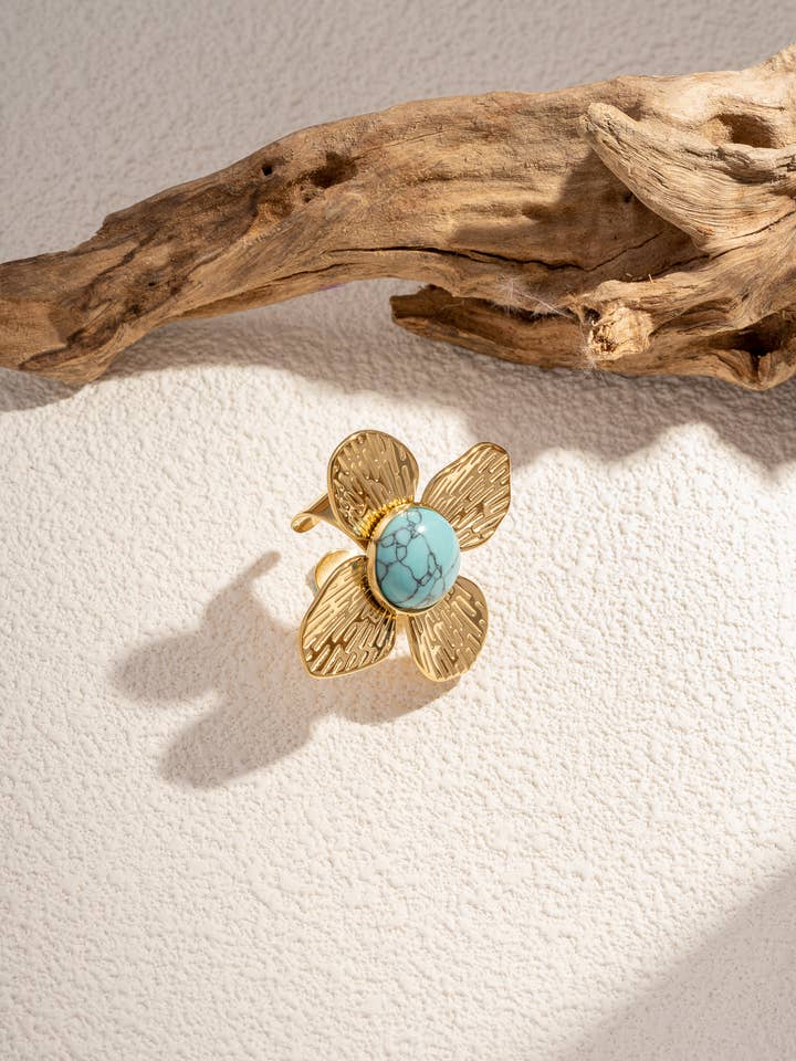 Flower ring adorned with stone, adjustable in stainless steel for wholesale by COSMOS