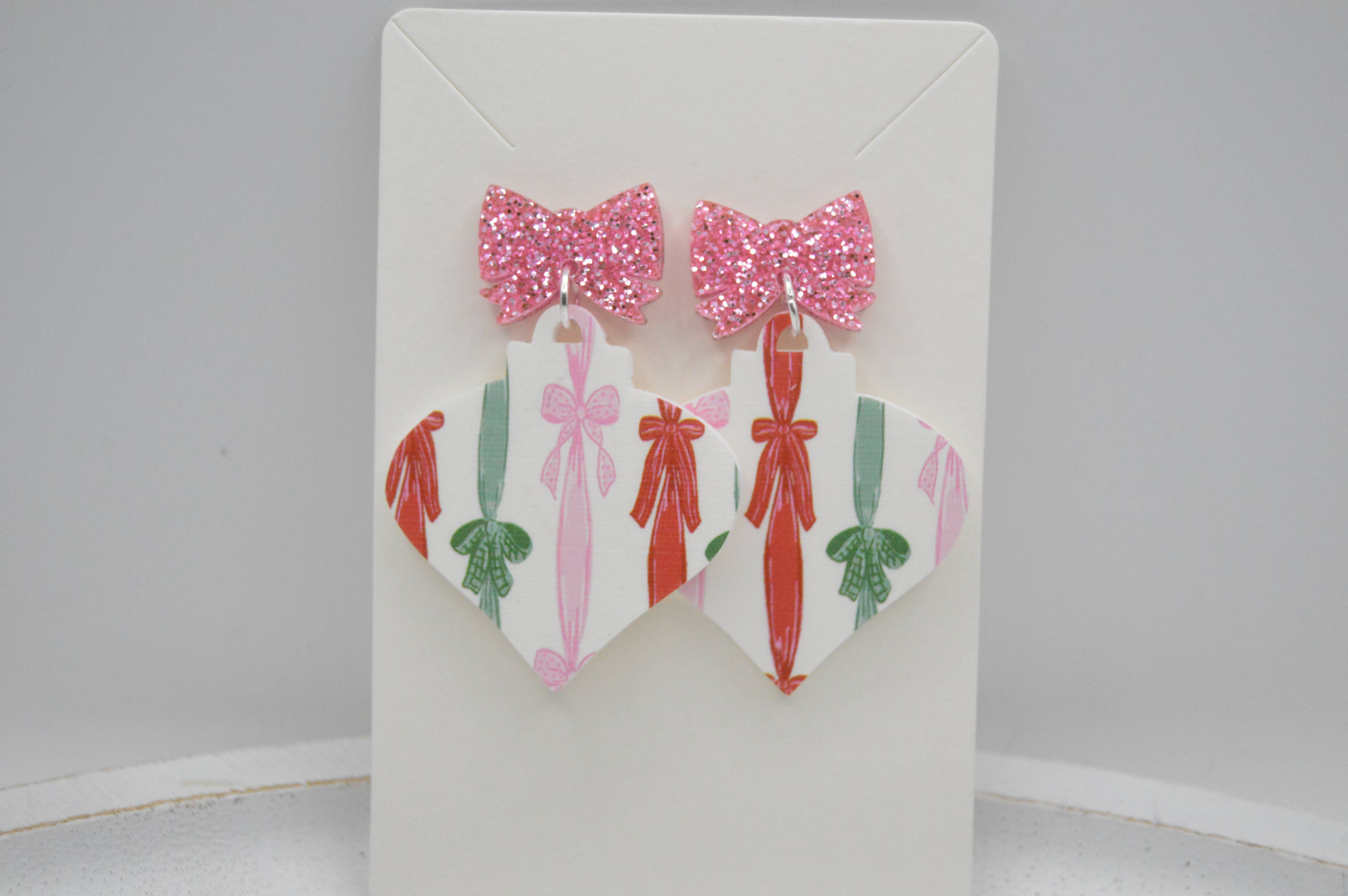 The Adorned Fox - Wholesale Dangle Earrings - Coquette Ribbon Christmas
Bauble, Acrylic Earrings, Bow