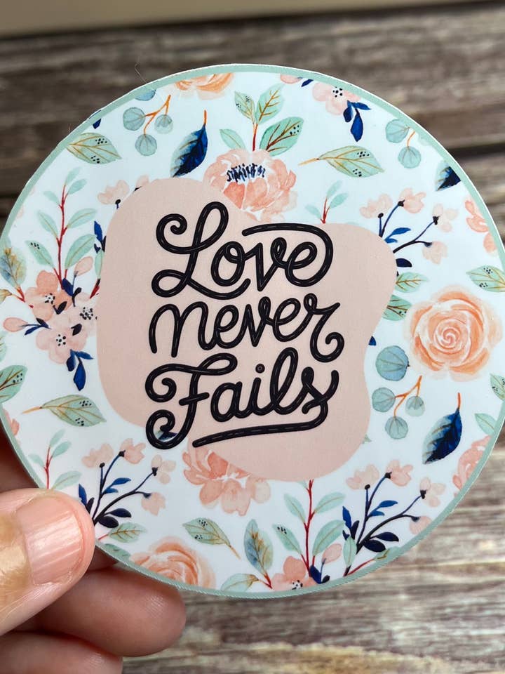 Love never fails vinyl sticker, 3”x3” for wholesale by Prickly Petal Boutique