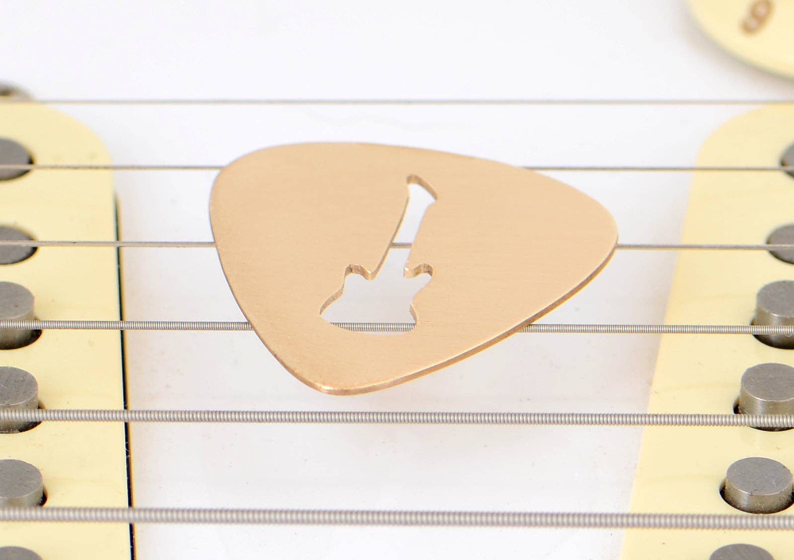 NiciArt LLC - Wholesale Music Accessory - Guitar Pick rocking out a Guitar Cut Out in Bronze2