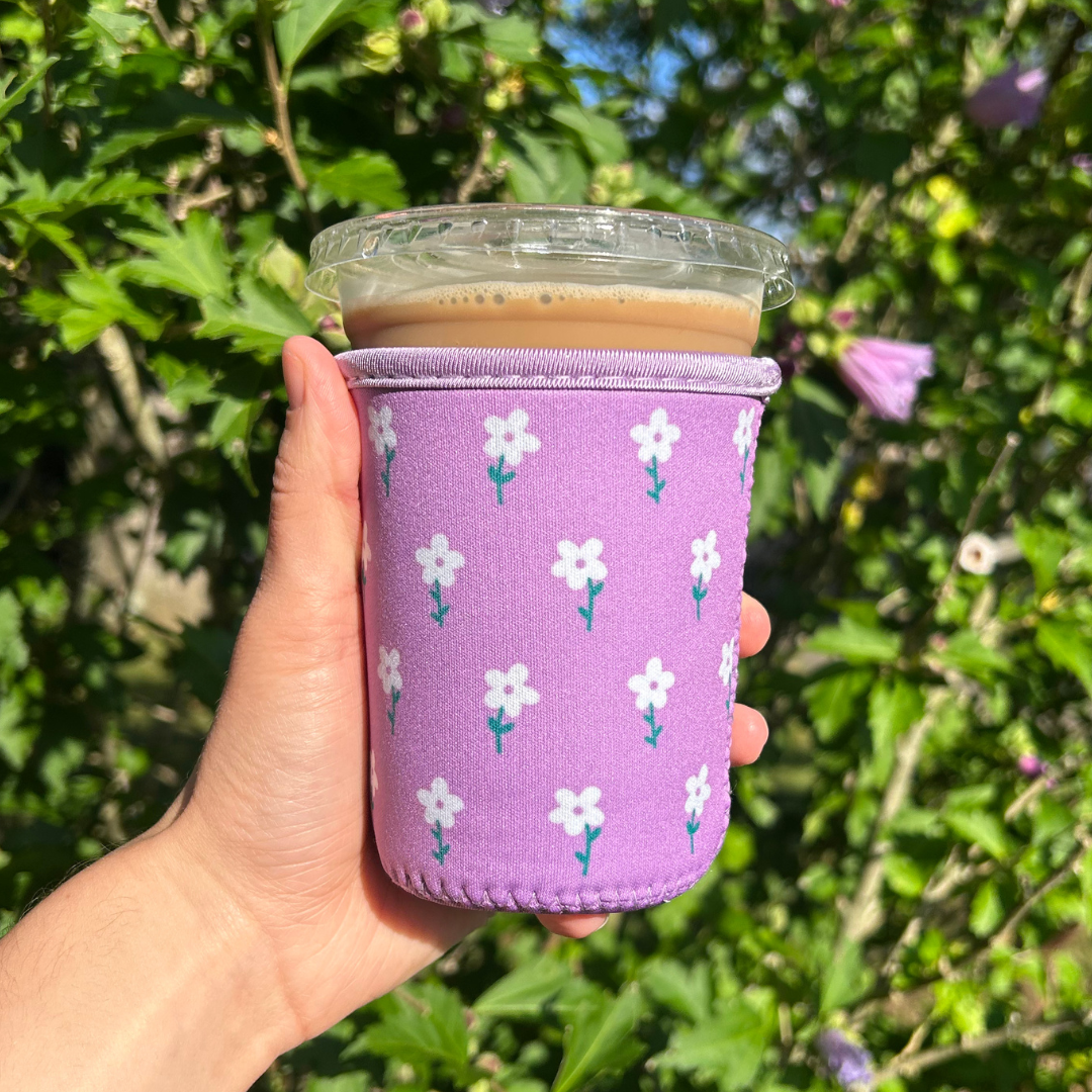 Sun and Mind Co. - Wholesale Drink Huggers & Koozies - Purple and White Flower Field Iced Coffee Drink Sleeve0