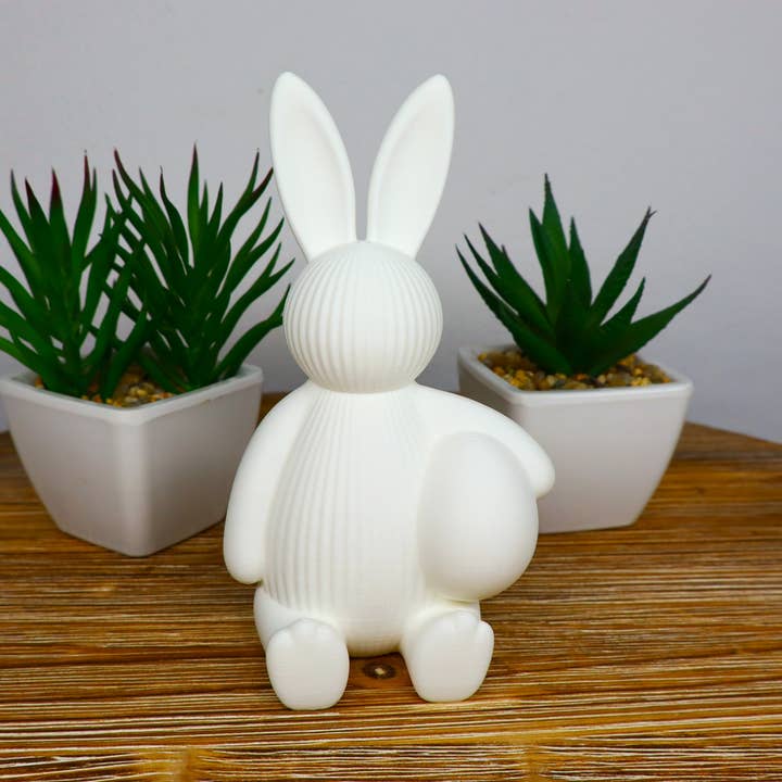 Påskeharefigur, der holder æg, sød forårsdekoration for engroshandel hos Herbs&Belles