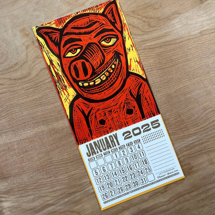 Pioneer House (formerly Yee-Haw) - Wholesale Calendar - 2025 Smiling Pig Woodcut Mini Calendar