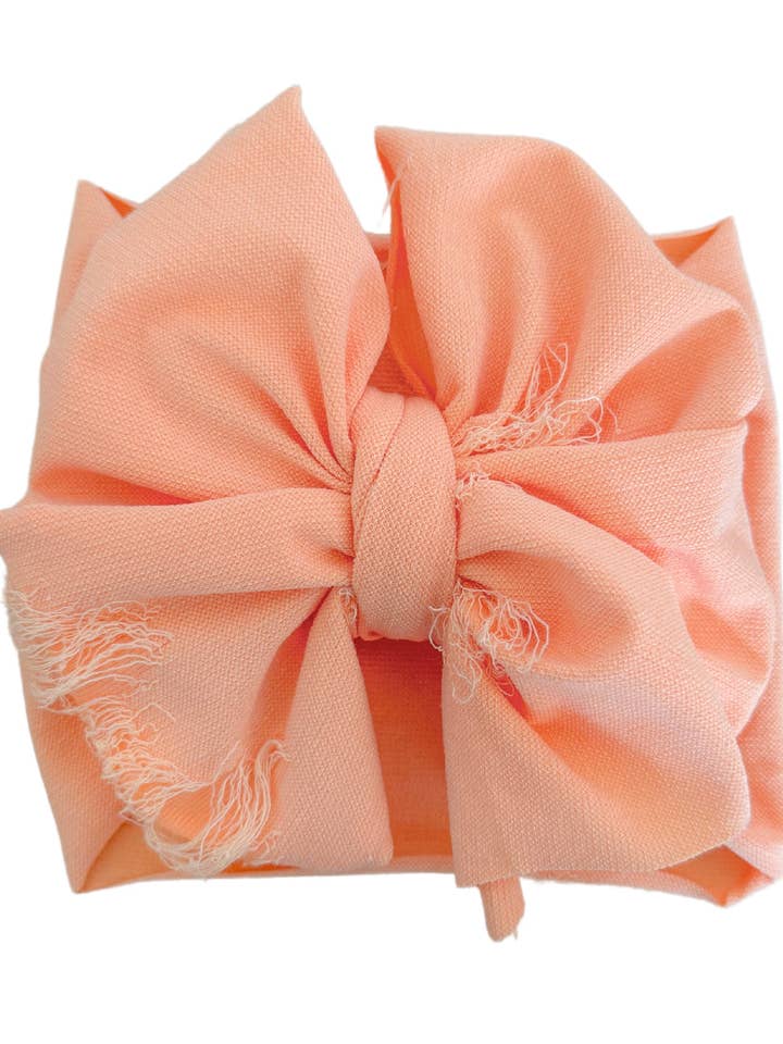 Distressed huvudband rosett - Creamsicle för wholesale av Elle & Mily