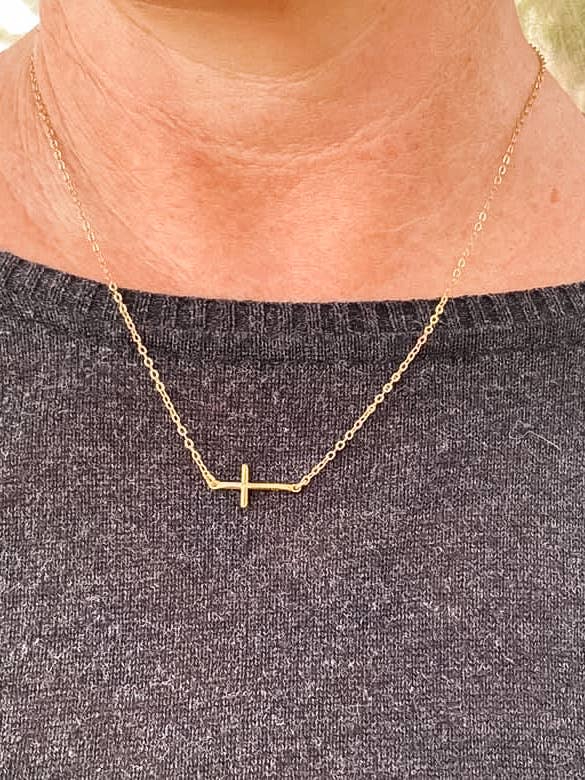 Gold sideways cross necklace for wholesale by Rose Burkhardt Jewelry