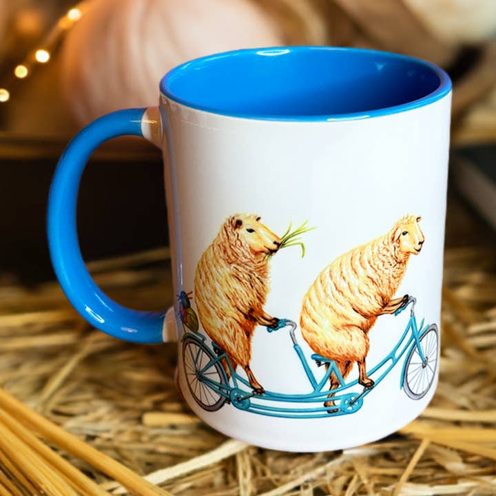 Sheep riding a Bike Mug for wholesale by Sardines Studio