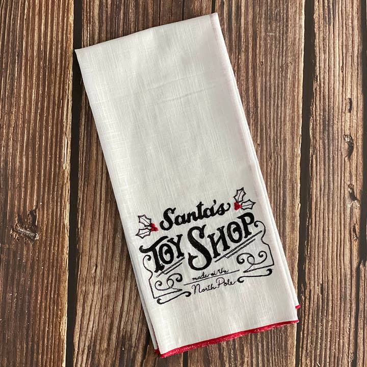 Mutli Santas Toy Shop Embd. Kitchen Towel for wholesale on Faire0