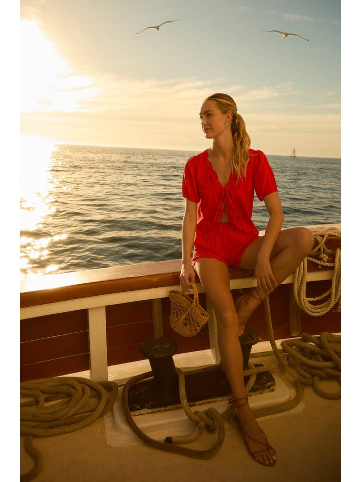 Red EYELET EMBROIDERD FRONT TIES TOP AND SCALLOP SHORTS for wholesale on Faire