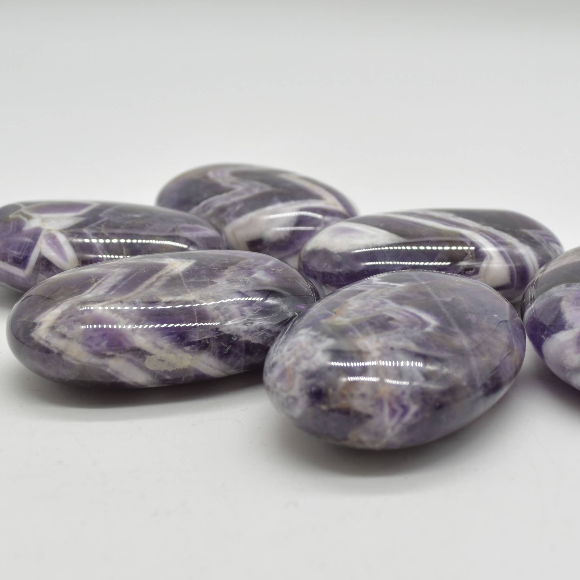 Purple Chevron Amethyst Crystal Palm Stone - 6 cm - 1 Count for wholesale on Faire1