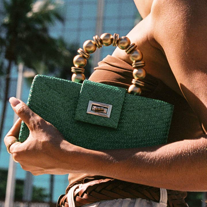 Emerald Green Statement Clutch | Handwoven, Gold Bead Handle for wholesale by Soli & Sun