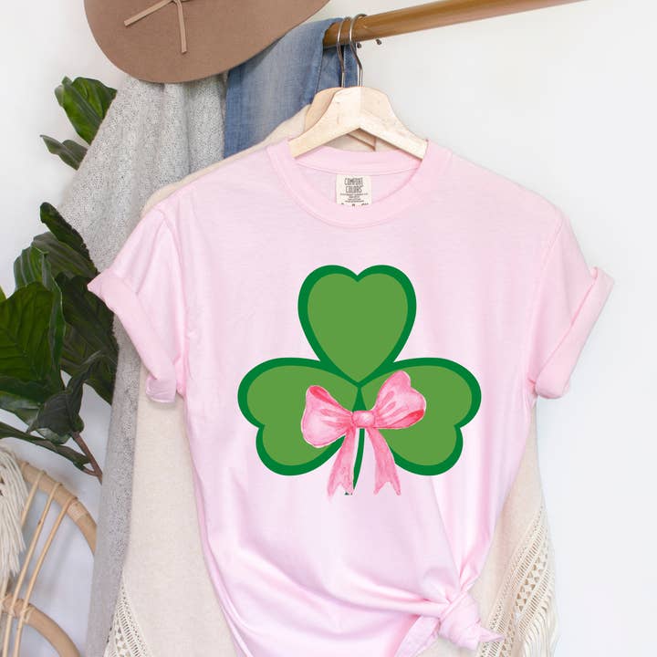 St Patricks Clover Bow Comfort Colors Tee for wholesale by The Luna T Company