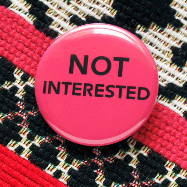 NOT INTERESTED 1.25" Pinback Button Feminist Pin for wholesale by Word For Word Factory
