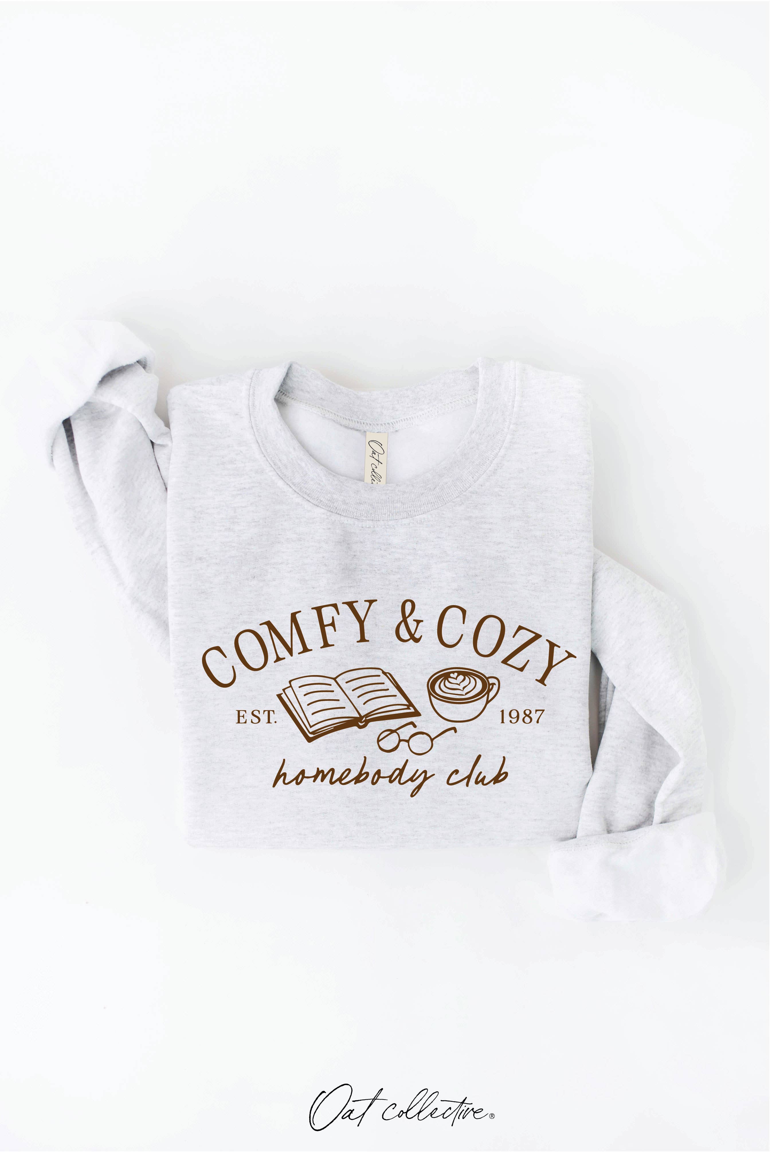 OAT COLLECTIVE – Camisola gráfica - Mulher por atacado – Moletom Gráfico Unissex COMFY AND COZY HOMEBODY CLUB1