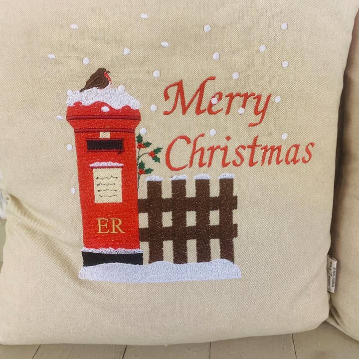 Christmas Post Box Cushion. Merry Christmas / Nadolig Llawen Letters to Santa Cushion snowy postbox and robin nostalgic Xmas scene handmade Christmas cushion for wholesale by Lizzie Dixon Designs