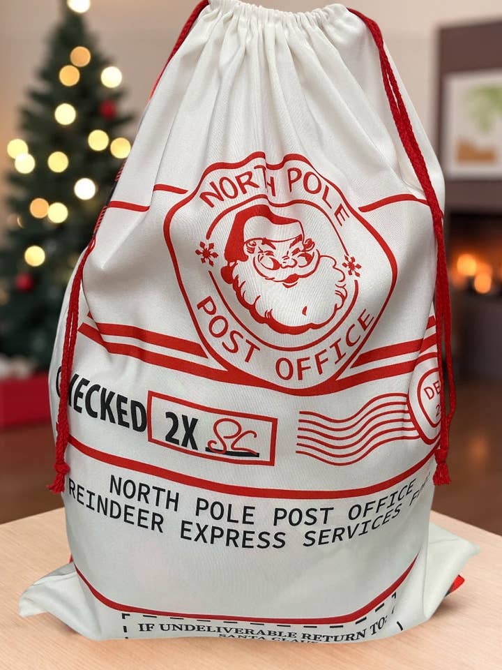 19" X 27"North Pole Post office Checked twice" Santa printed Christmas sack. SC-19 for wholesale by Kids Charm Online